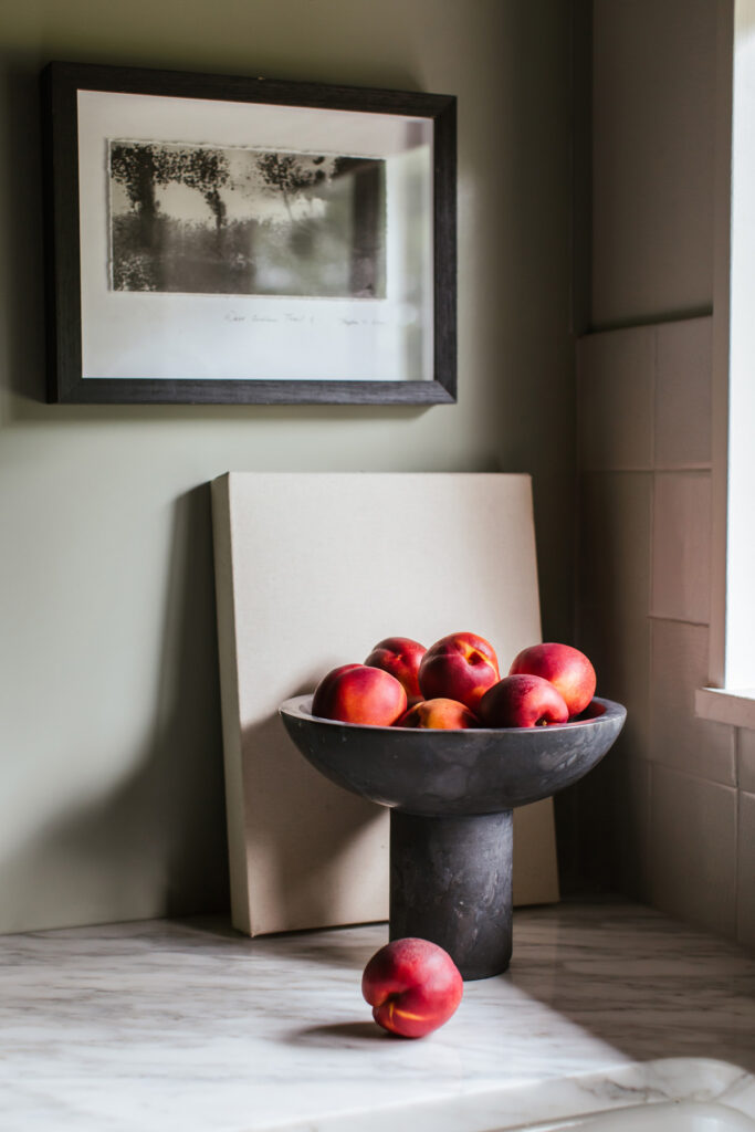 kitchen details with artwork and dish of peaches