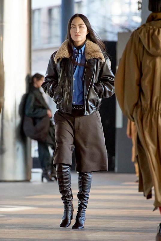 Lemaire for Fall 2023 ladies culottes with tall leather boot and bomber jacket