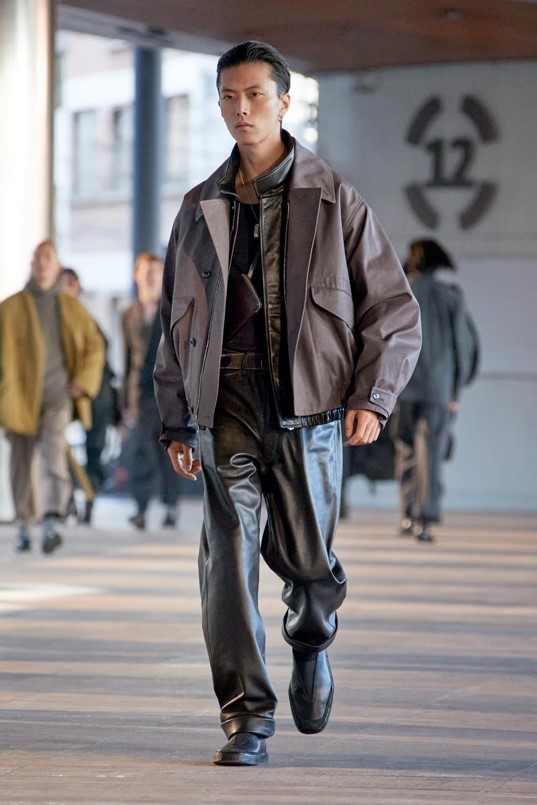 Lemaire for Fall 2023 mens leather pants layered with canvas jacket in muted grays and browns
