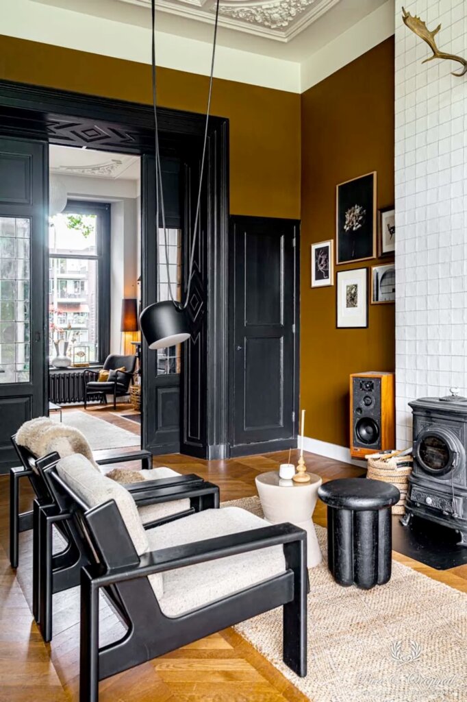 Living room with formal ceilings, parquet floors, black trim, modern furniture and walls painted praline