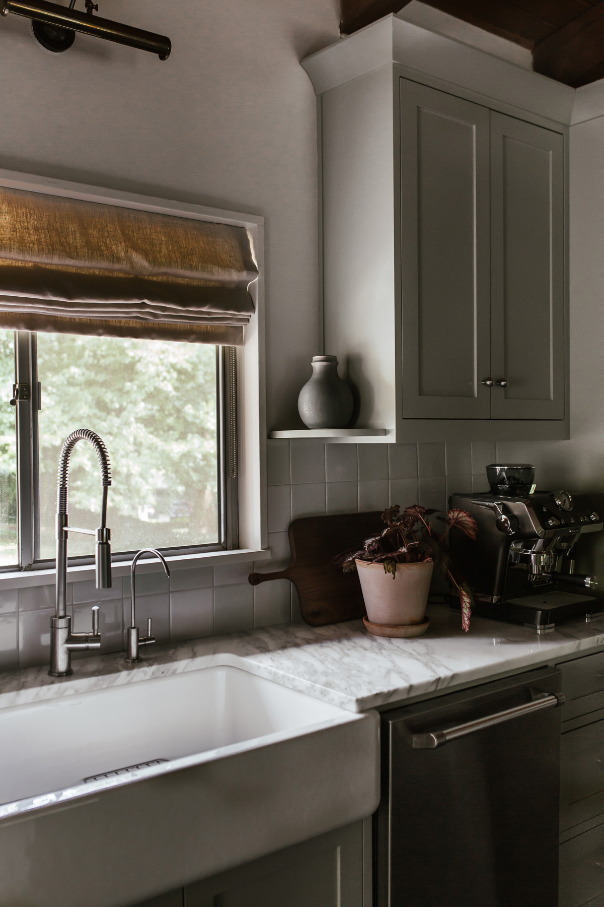 kitchen with farmhouse sink and pale gray-green cabinets