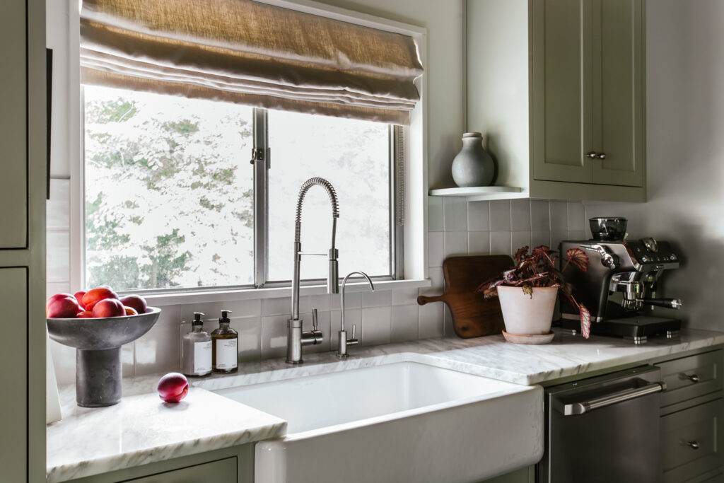 Close up view of the farmhouse sink and delft backsplash