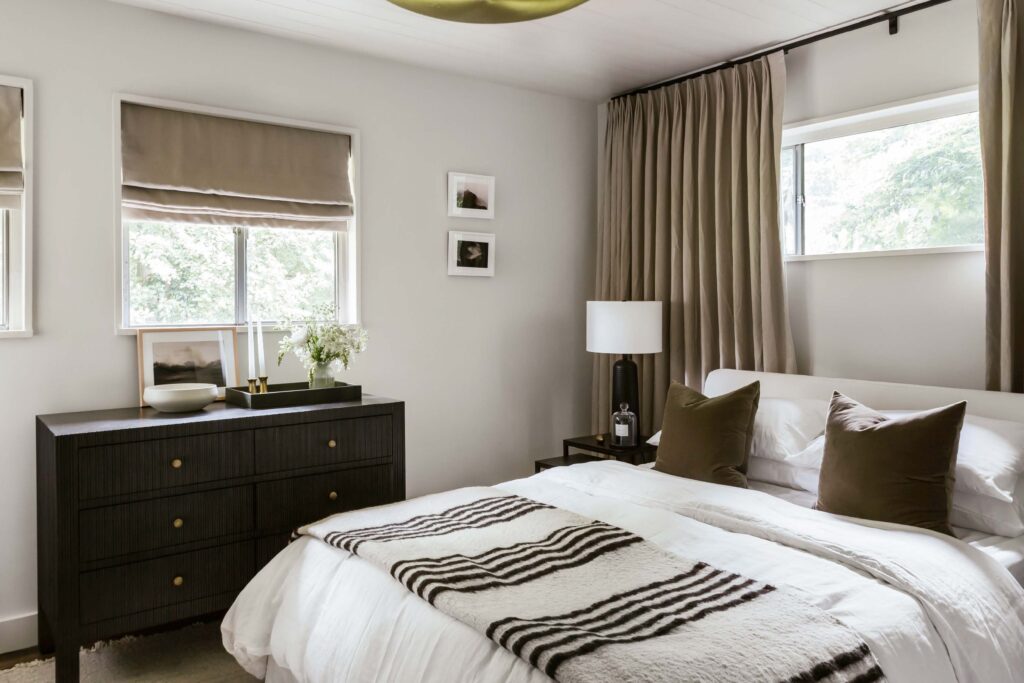 Full view of Guest Room 1 in neutral tones with contrasts of dark brown.