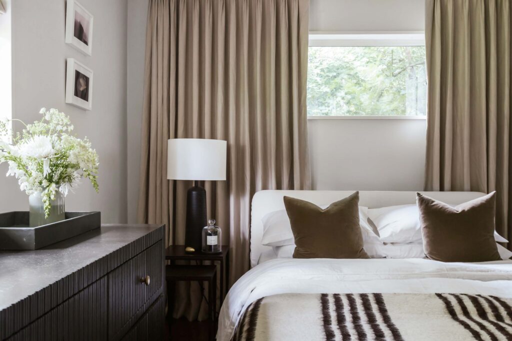 Guest room 1 close up of bed and tan drapes