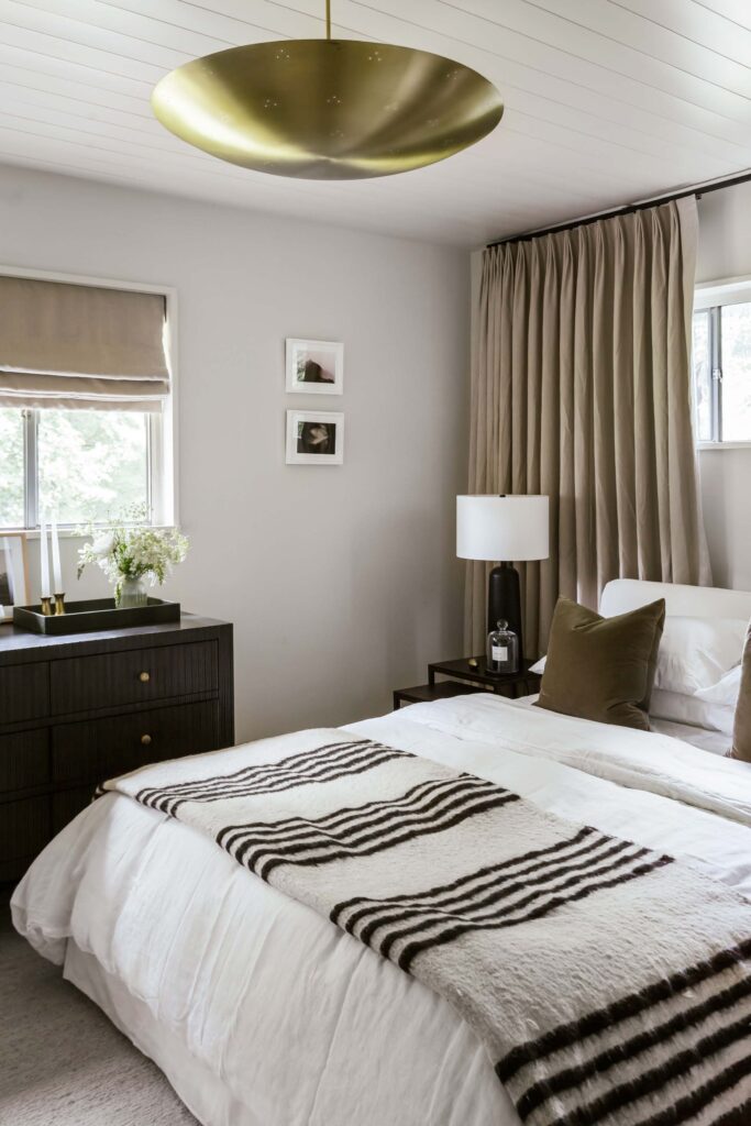 side angle view of guest room 1 featuring a polished brass bowl light fixture