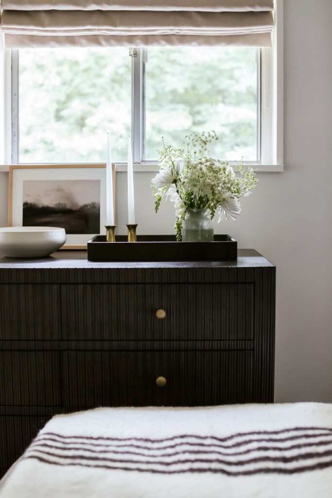 detail view of guest room 1 credenza with bouquet of flowers