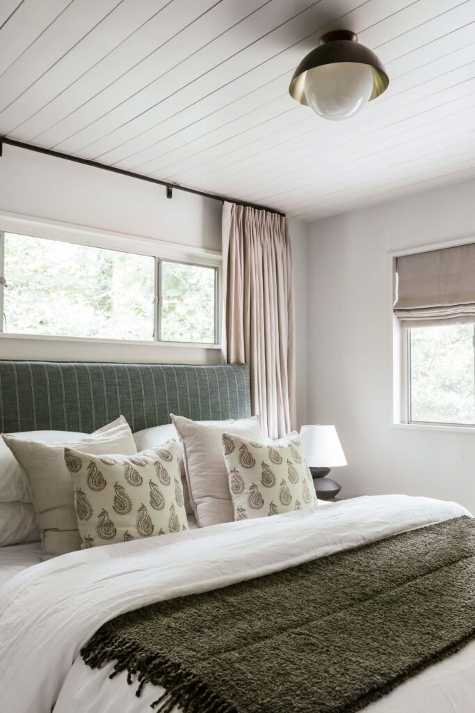 Guest room 2 bed with neutral tones accent with gray-blue fabric headboard